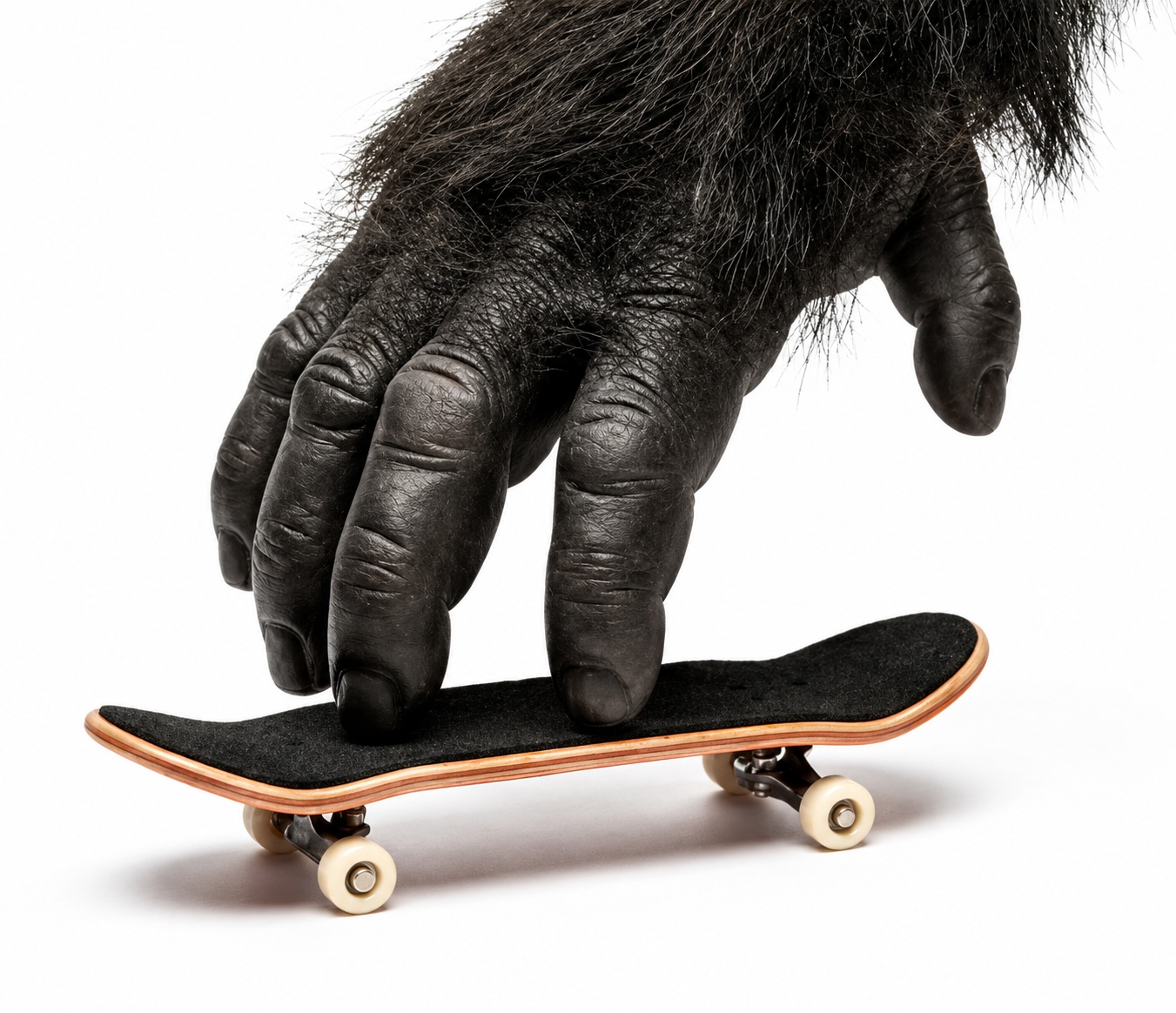 Gorilla hand playing with a tiny skateboard
